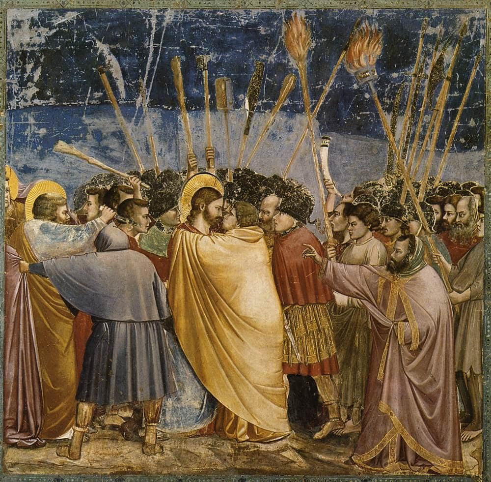 Giotto'nun Yahuda'nın Öpücüğü freski: sarı pelerinli Yahuda İsa'yı sarıyor, etrafta meşaleler ve mızraklar