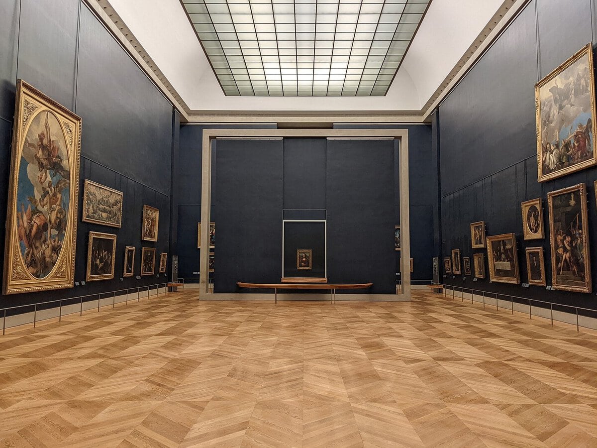 Louvre'daki Salle des États salonu ve camın arkasında sergilenen Mona Lisa